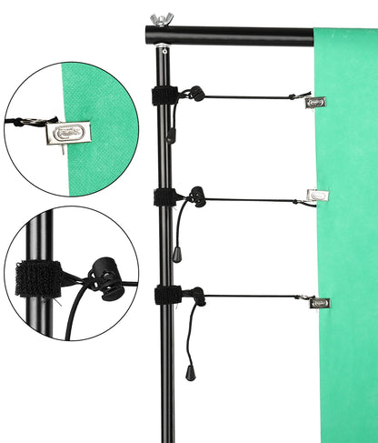 Black adjustable aluminum backdrop support system with clips and tension cords holding a green muslin background