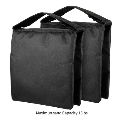 Pair of black fabric sandbags with handles for stabilizing photography backdrop stands or lighting equipment