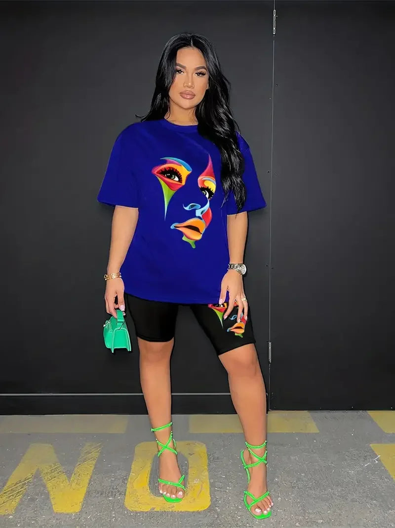 Woman wearing a chic two-piece outfit with a blue t-shirt and black skinny shorts featuring colorful abstract face prints