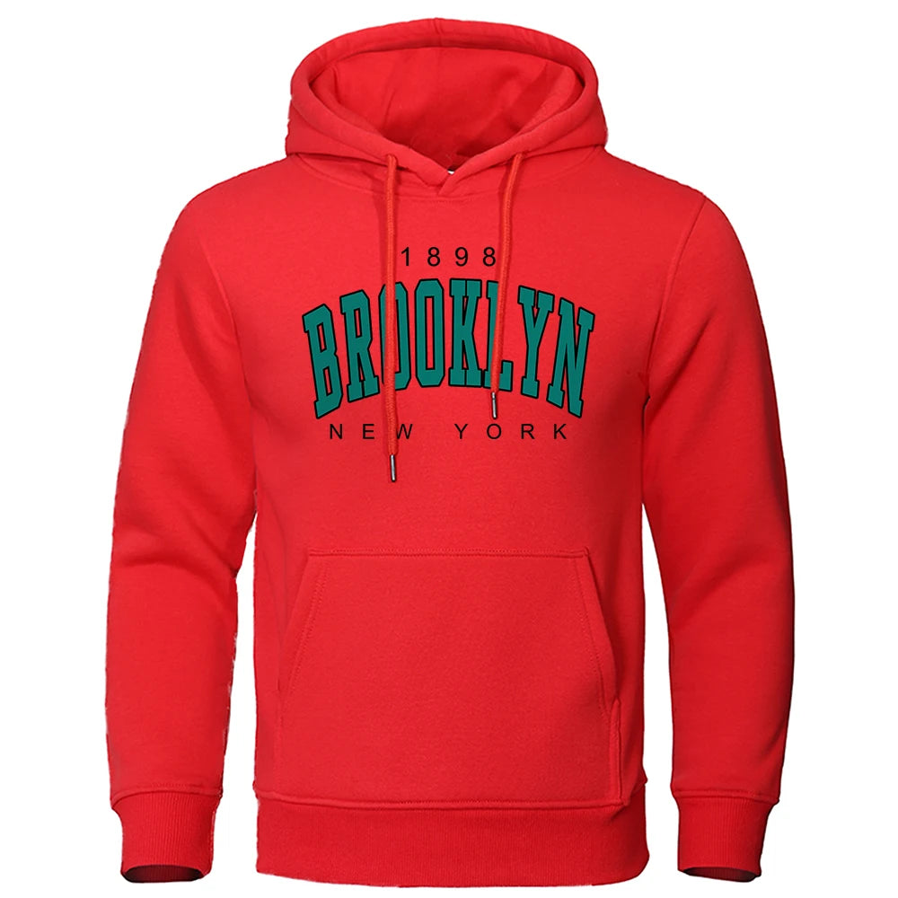 Red urban hoodie for men with Brooklyn New York vintage-style print and front kangaroo pocket on white background