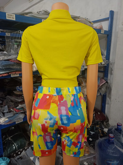 Mannequin wearing a yellow short-sleeve top and colorful abstract print shorts two-piece summer outfit from the back