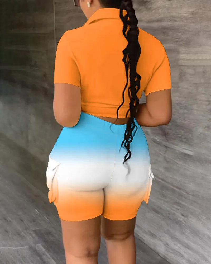 Woman wearing a two-piece summer outfit with a fitted short-sleeve orange top and gradient blue to orange shorts with pockets
