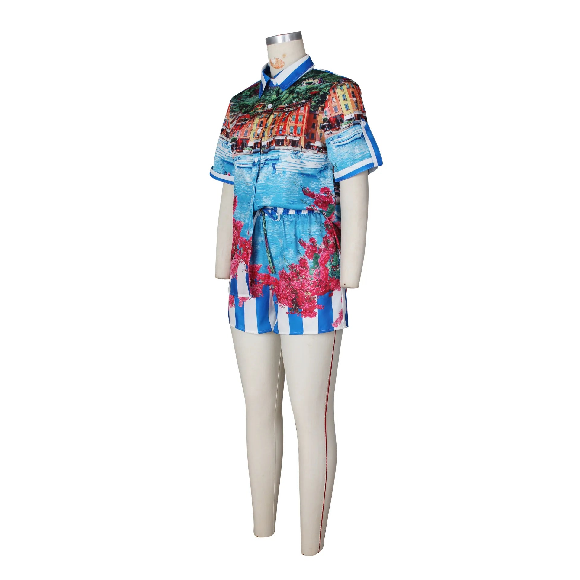 Woman's two-piece vacation outfit with colorful printed short-sleeve shirt and matching shorts on mannequin