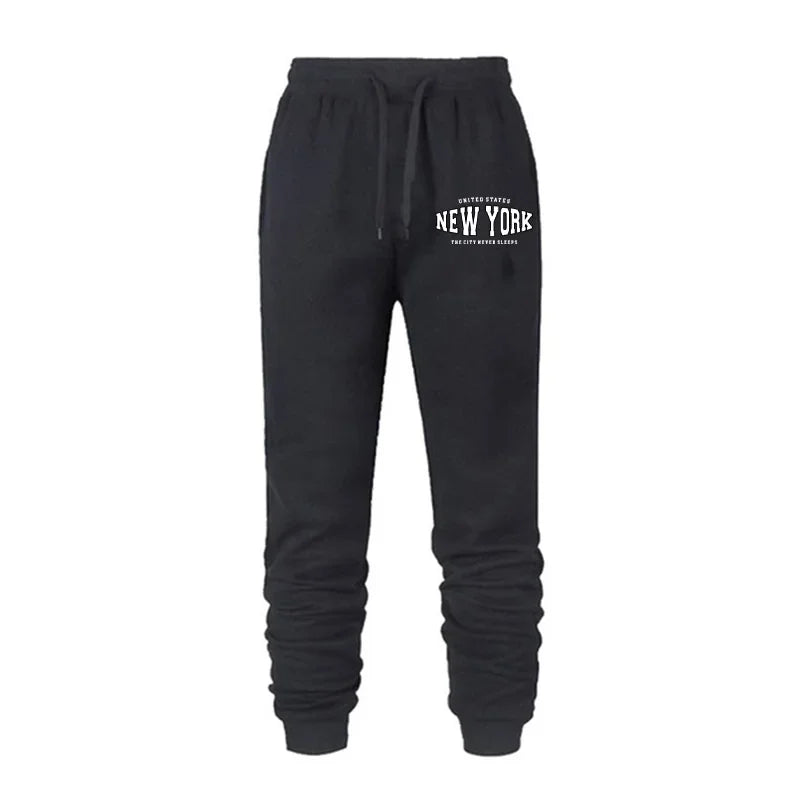 Black women's jogger pants with elastic waistband and white New York graphic print on front thigh