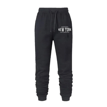 Black women's jogger pants with elastic waistband and white New York graphic print on front thigh
