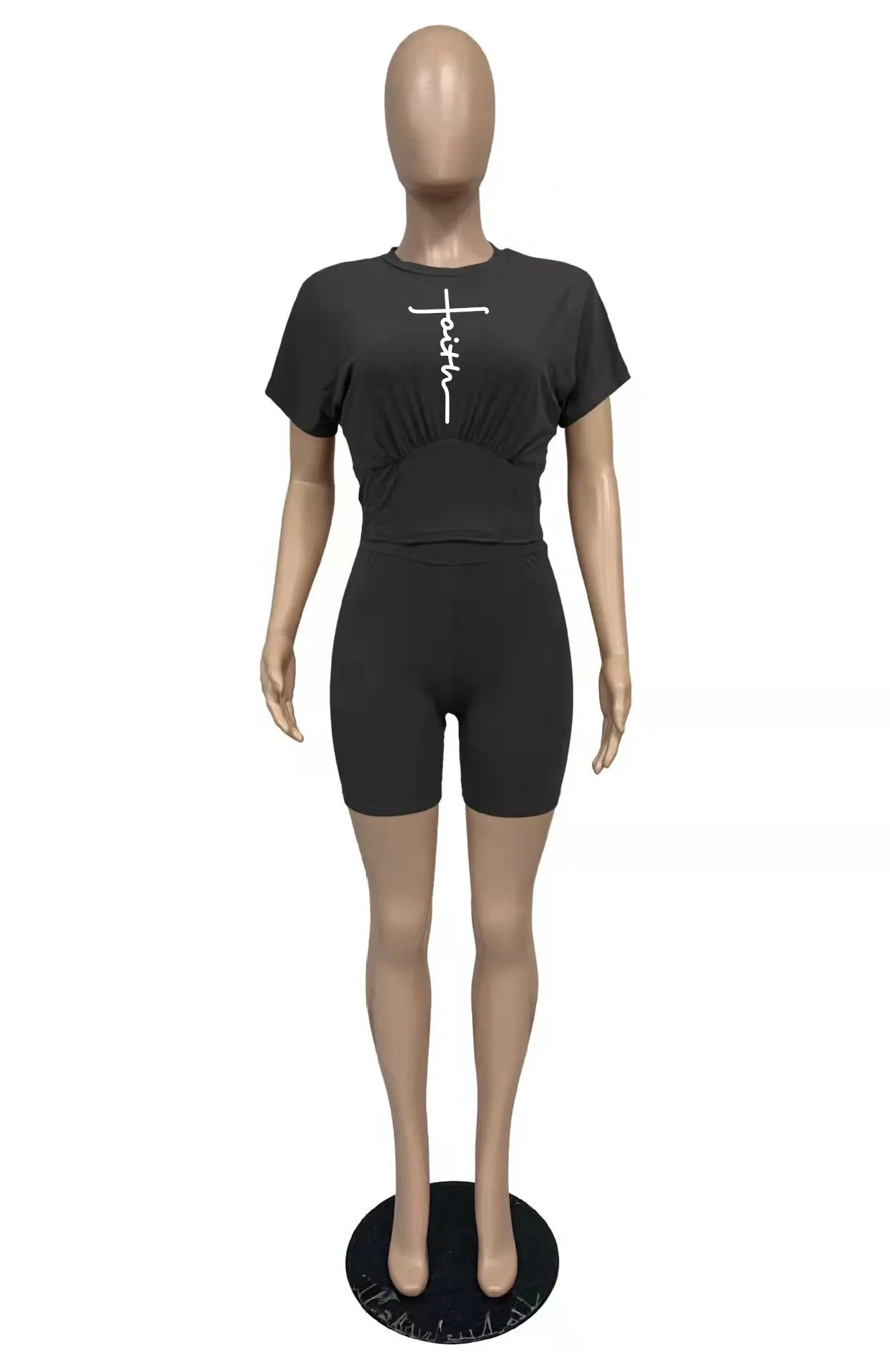 Mannequin wearing a black two-piece set with a cropped t-shirt and matching high-waisted shorts.