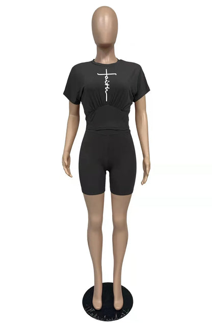 Mannequin wearing a black two-piece set with a cropped t-shirt and matching high-waisted shorts.