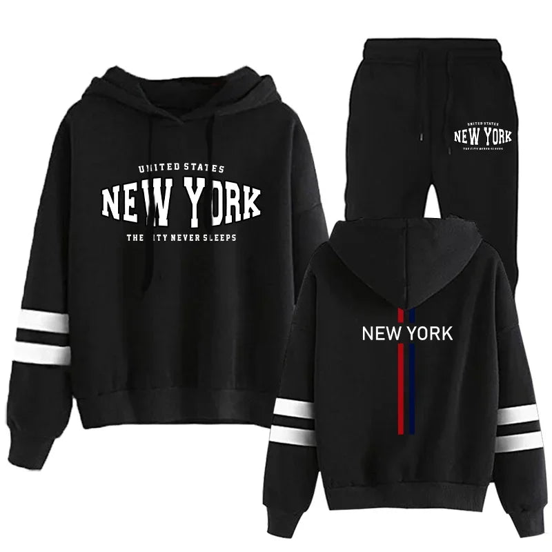 Black two-piece women's tracksuit with hood, white stripes on sleeves, and New York printed on front and back