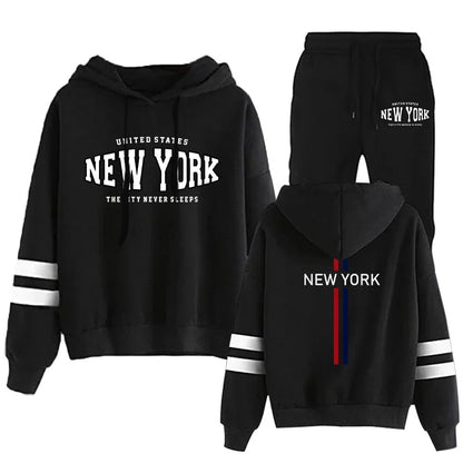 Black two-piece women's tracksuit with hood, white stripes on sleeves, and New York printed on front and back