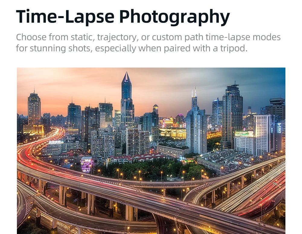 City skyline at dusk with light trails on busy highway overpasses showcasing time-lapse photography effect