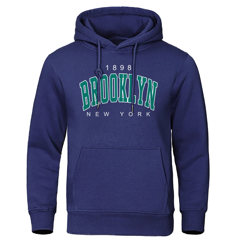 Navy blue urban style men's hoodie with Brooklyn New York vintage print and front kangaroo pocket on white background