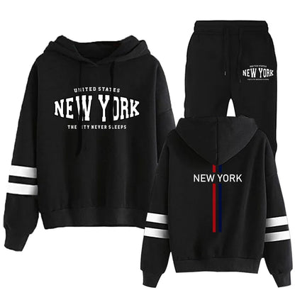 Black two-piece women's jogging set with hooded sweatshirt and pants featuring New York text and white stripe details on sleeves