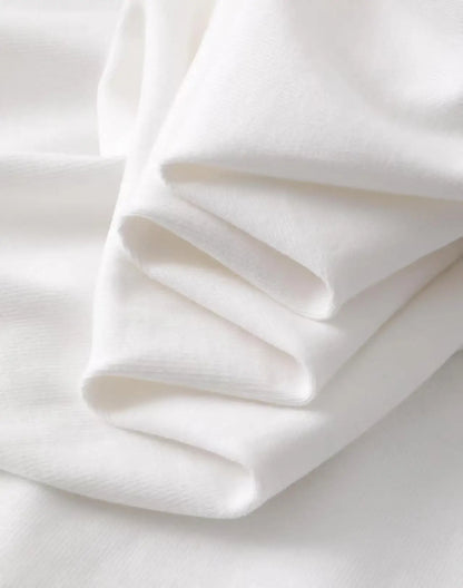 Close-up of soft folded white fabric detail for a Harajuku style artistic painted face t-shirt