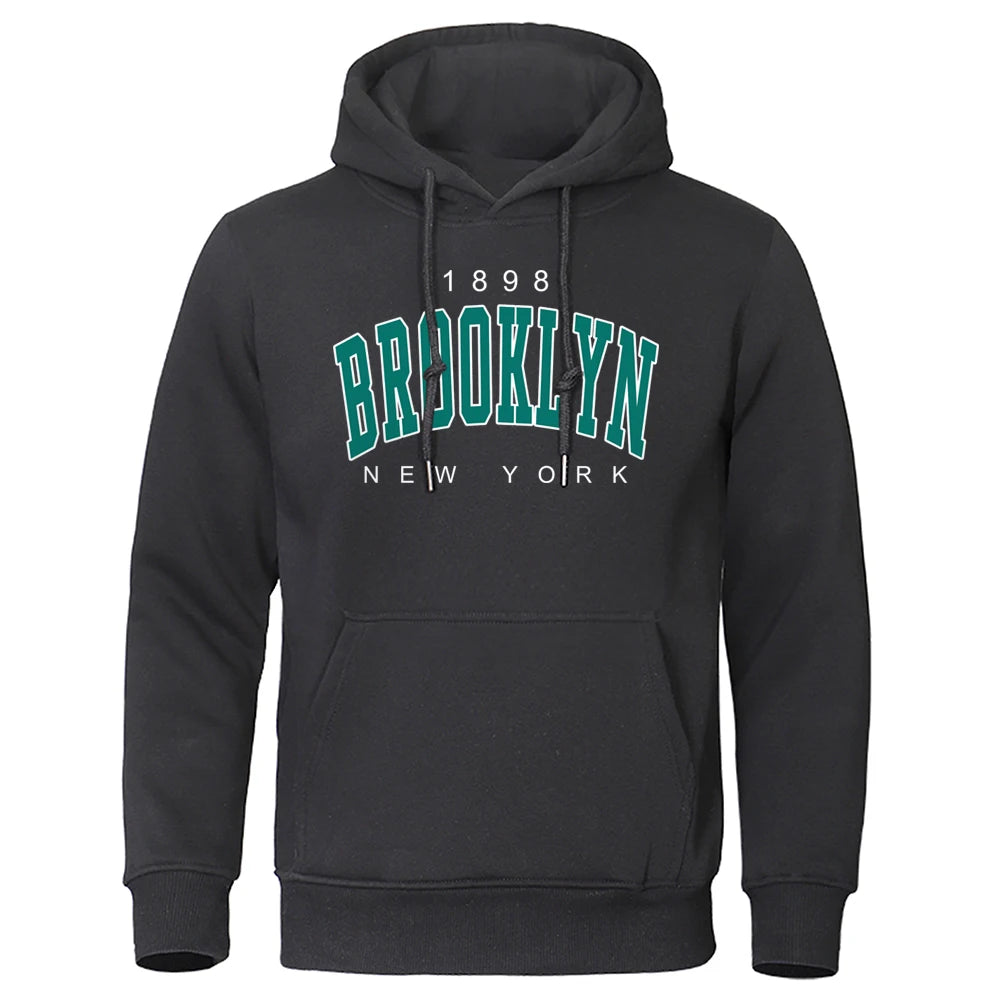 Black urban hoodie for men with Brooklyn New York vintage style and front kangaroo pocket on white background
