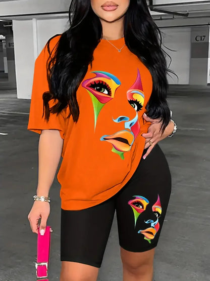 Woman wearing a two-piece outfit with an orange graphic t-shirt and black fitted shorts featuring a colorful face print