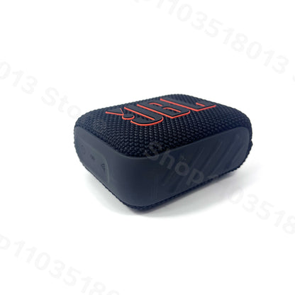 Compact black JBL GO 4 Bluetooth speaker with textured fabric and red logo on a white background