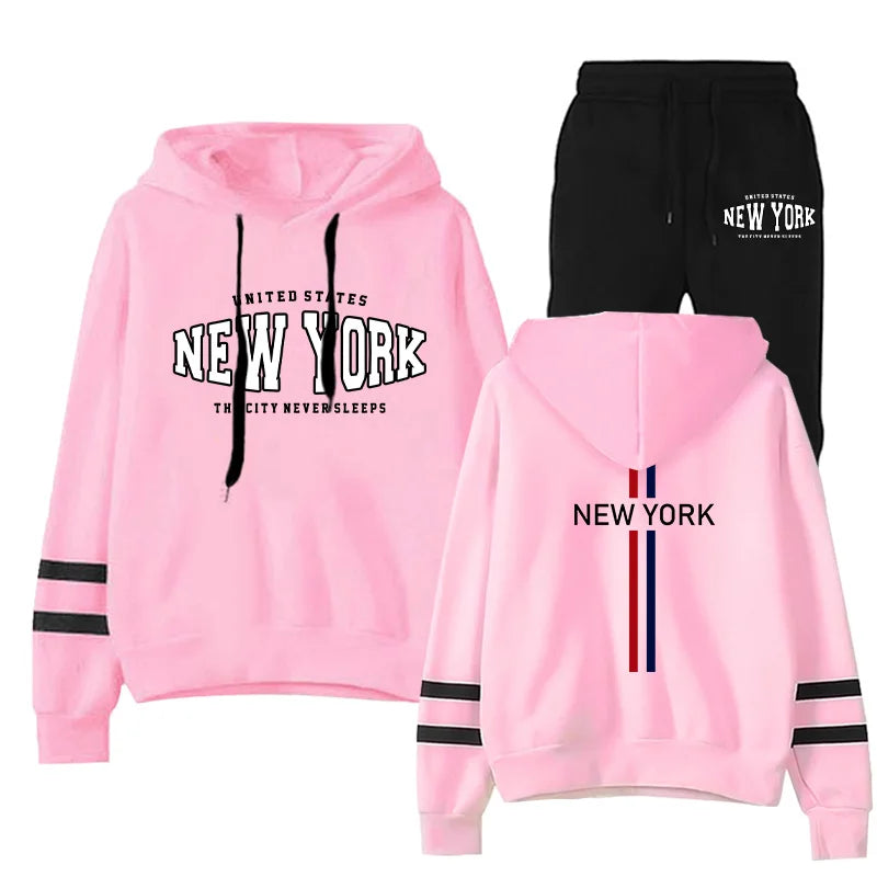Women's two-piece jogging set with pink striped hoodie and black drawstring shorts featuring New York text print