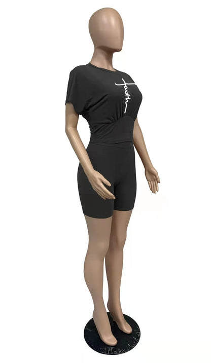 Female mannequin wearing a black two-piece summer set with a graphic t-shirt and fitted shorts