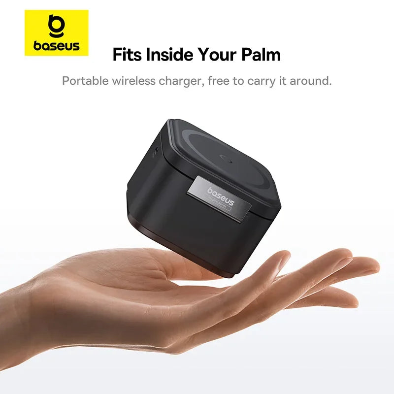 Compact black Baseus wireless charger resting on an open palm against a white background