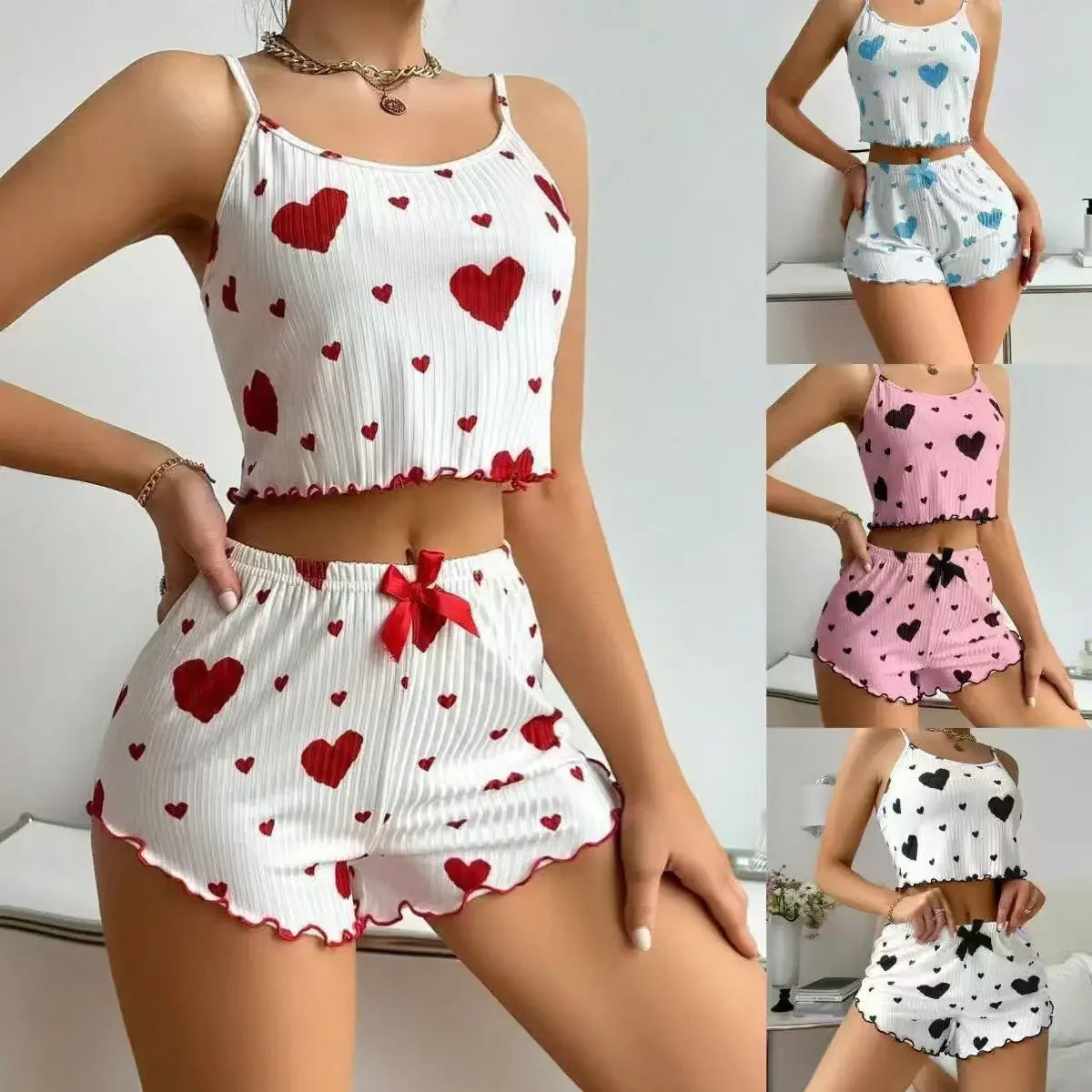 Woman wearing a two-piece heart print pajama set with cropped camisole and ruffled shorts in multiple colors