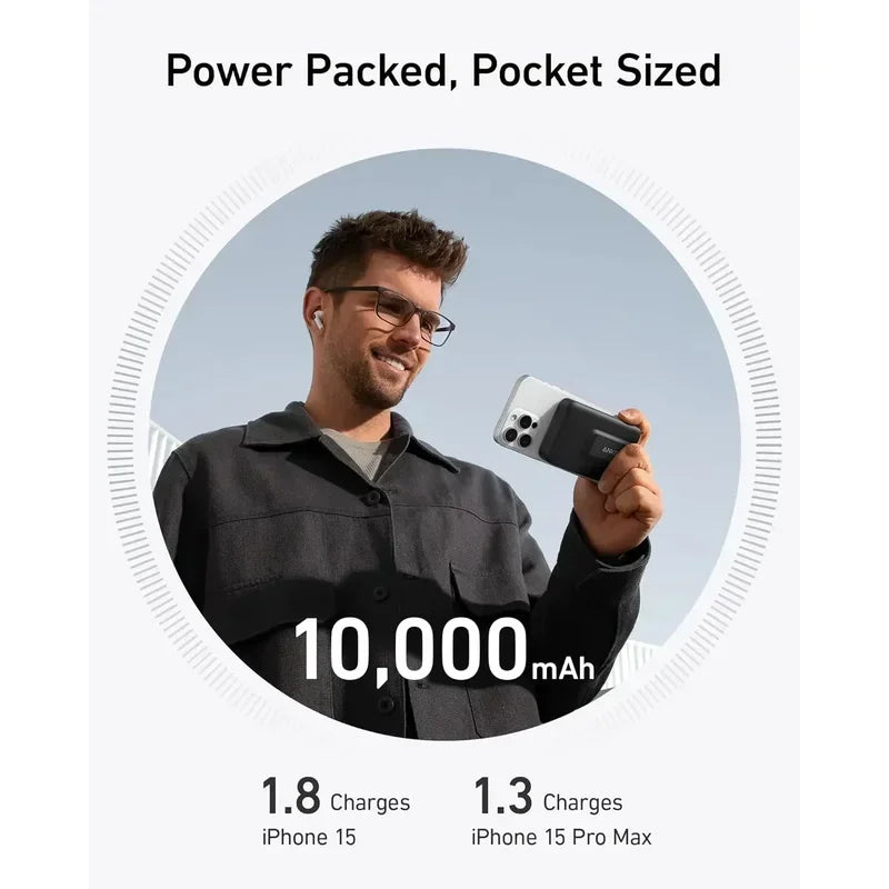 Man wearing glasses and earbuds holding compact Anker MagGo Power Bank with 10000mAh capacity outdoors