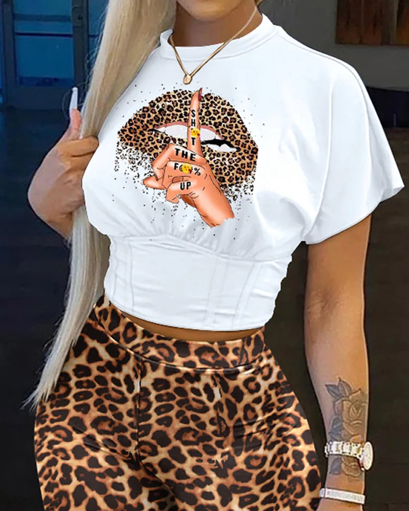 Woman wearing a white cropped t-shirt with leopard print lips graphic and leopard print high-waisted shorts summer outfit