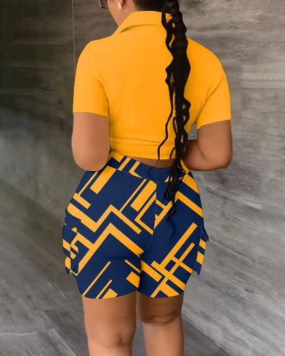 Woman wearing a yellow short-sleeve tied top and high-waisted blue and yellow geometric print shorts summer outfit