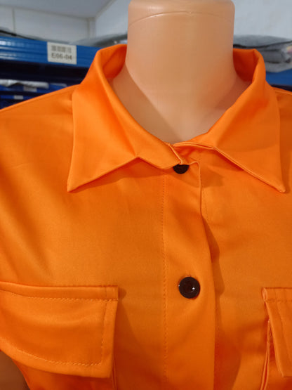 Close-up of orange short-sleeve summer top with collar and chest pockets on mannequin