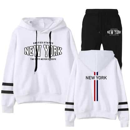 Women's two-piece jogging set with white striped hoodie and black pants featuring New York print design