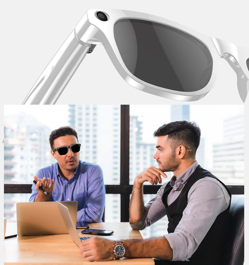 Close-up of white smart glasses with camera lens and two men discussing in office with laptop and phone on table