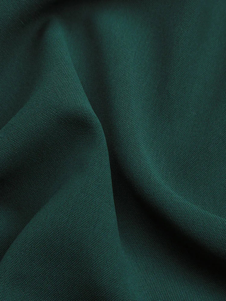 Dark green lightweight textured fabric close-up for summer women's beach dress material