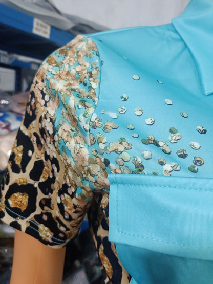 Close-up of a summer two-piece outfit with a blue top and short sleeve featuring leopard and floral print details