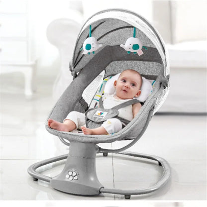 Baby sitting comfortably in a gray electric rocking chair with canopy and hanging toys in a bright room