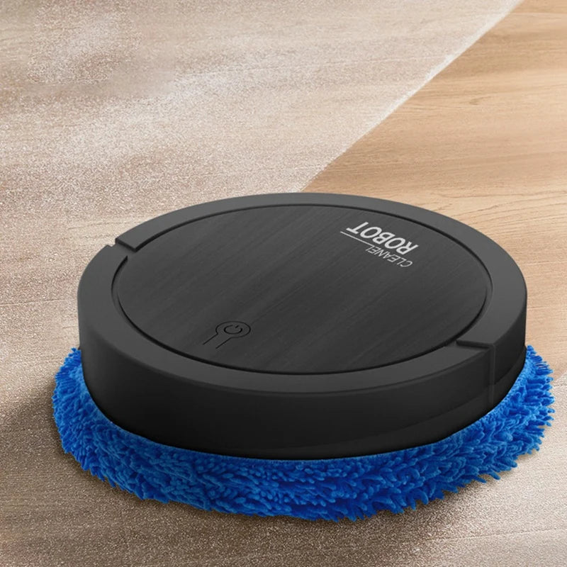 Black round smart cleaning robot with blue microfiber pad cleaning a wooden floor with dust and dirt