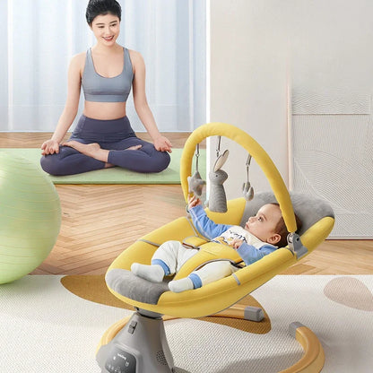 Baby lying in a yellow electric rocking chair with hanging toys while woman practices yoga in background