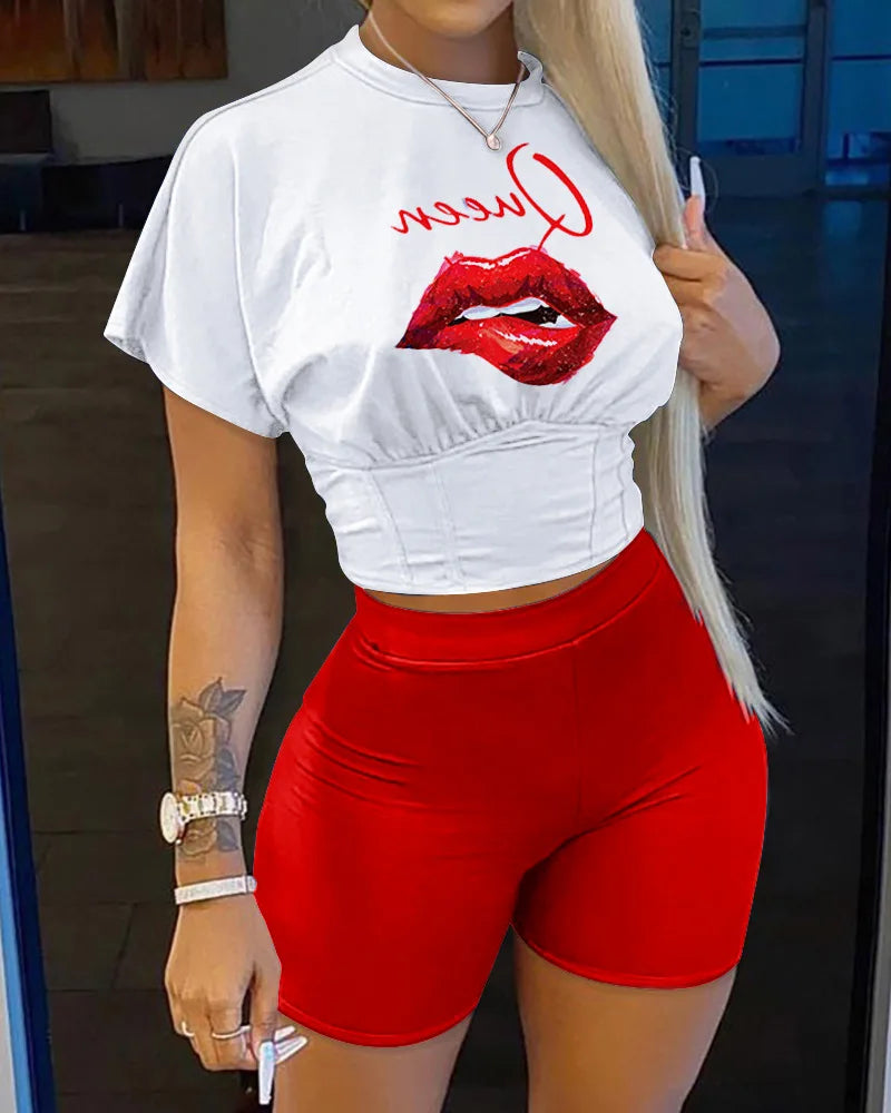 Woman wearing a white cropped t-shirt with red lips graphic and red high-waisted fitted shorts summer outfit