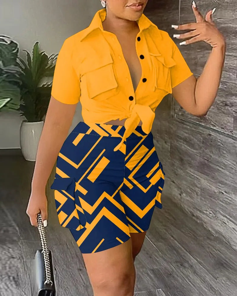 Woman wearing a two-piece summer outfit with a tied yellow short-sleeve top and patterned blue and yellow shorts with pockets