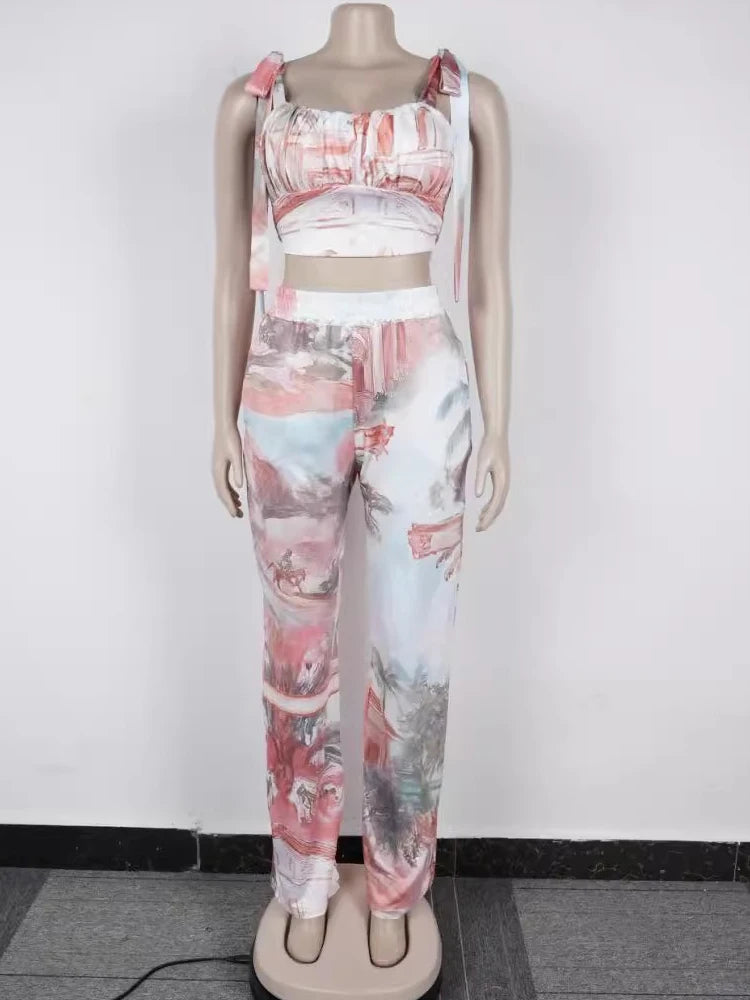 Female mannequin wearing a coral two-piece outfit with a ruched crop top and wide-leg pants in abstract print