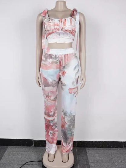 Female mannequin wearing a coral two-piece outfit with a ruched crop top and wide-leg pants in abstract print