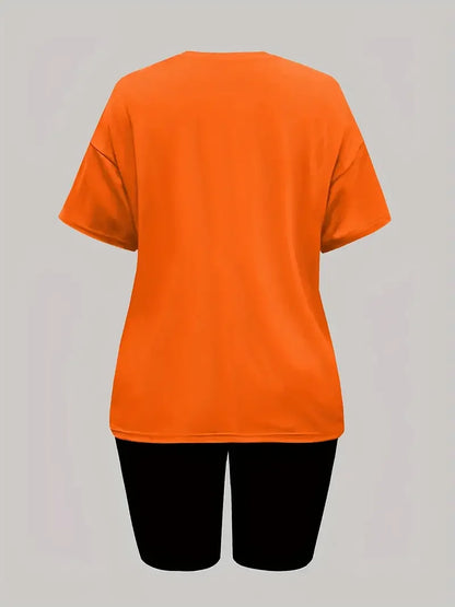 Woman wearing an orange short-sleeve t-shirt and black skinny shorts two-piece summer outfit shown from back