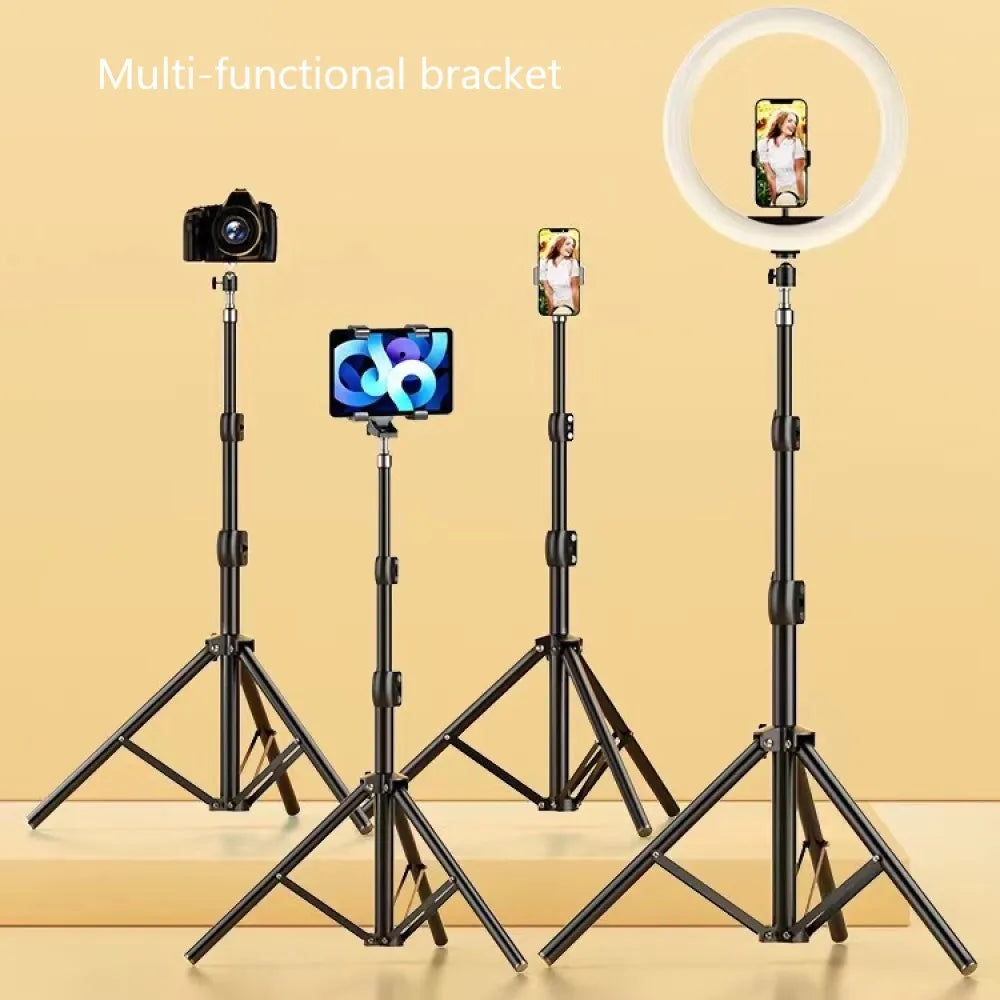 Four adjustable black multi-functional tripods holding camera, phone, tablet, and ring light with phone on beige background