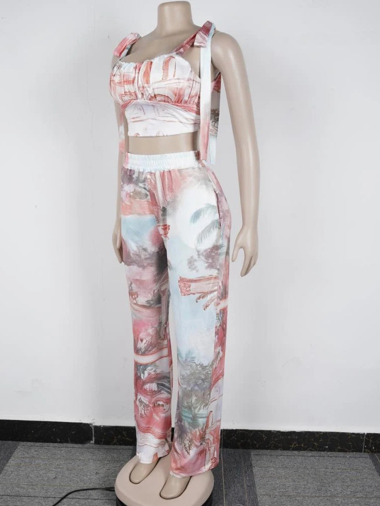 Female mannequin wearing a coral two-piece outfit with ruched cropped top and wide-leg pants with abstract print
