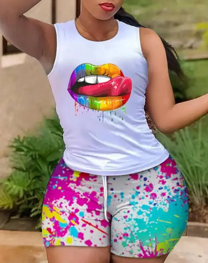 Woman wearing colorful paint splatter shorts and white tank top with rainbow lips print outdoors