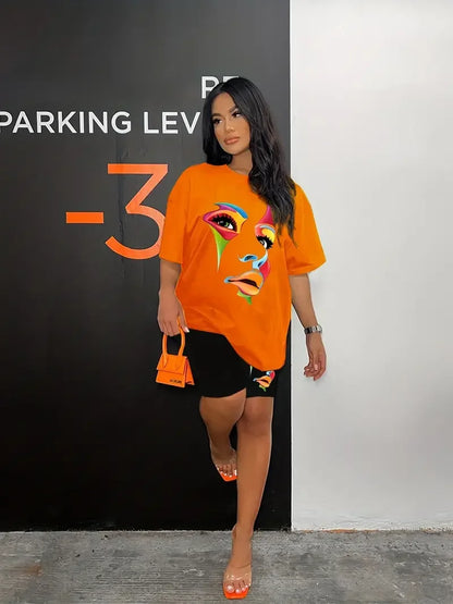 Woman wearing a chic two-piece outfit with a colorful graphic oversized t-shirt and black fitted shorts with matching design