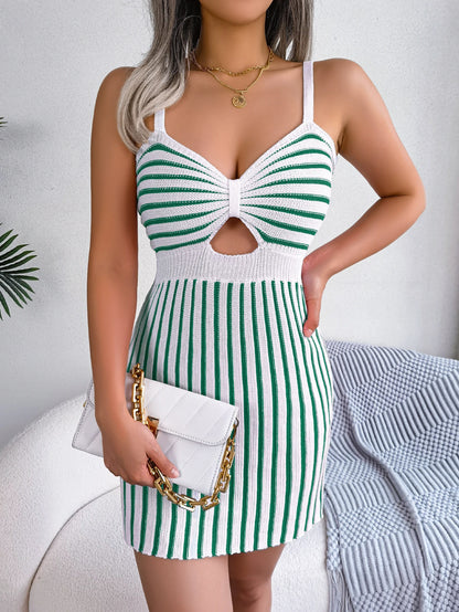 Woman wearing a casual summer striped dress with spaghetti straps and a cut-out detail, holding a white purse