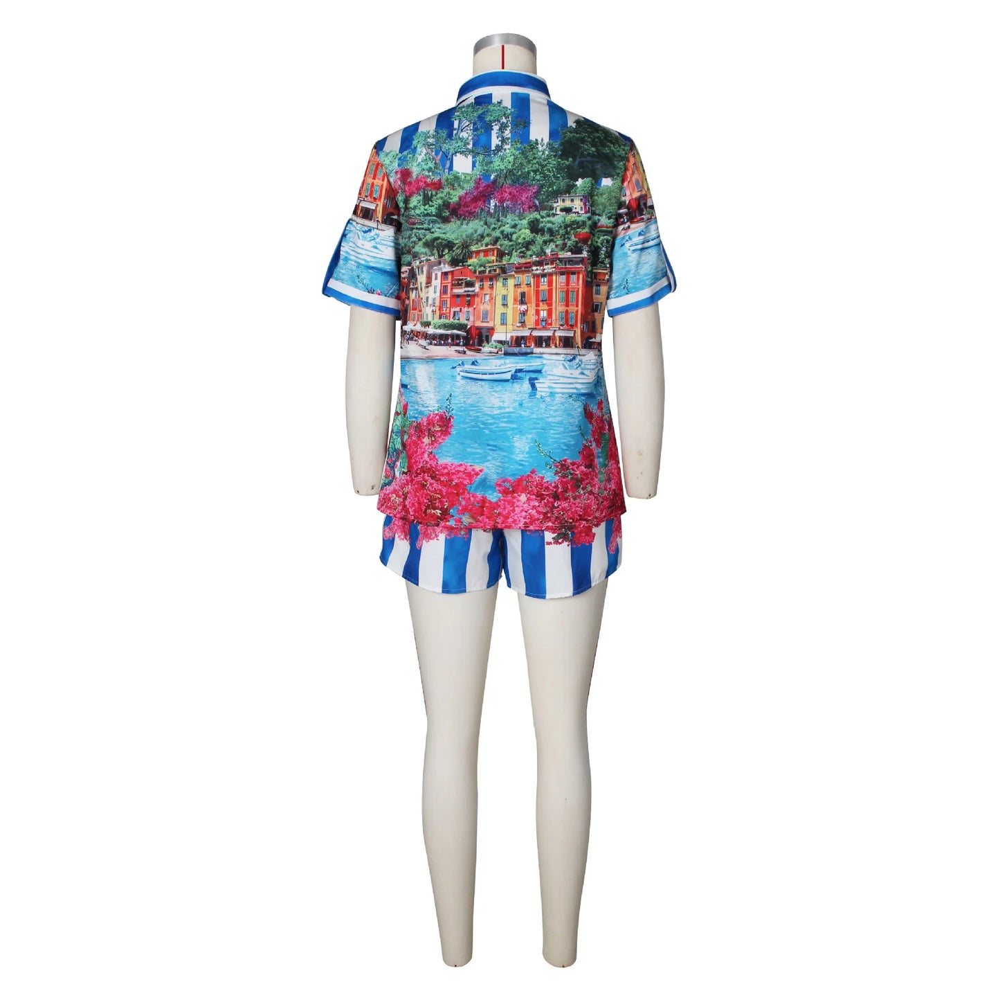 Female mannequin wearing a two-piece summer set with a colorful scenic print t-shirt and striped shorts viewed from back