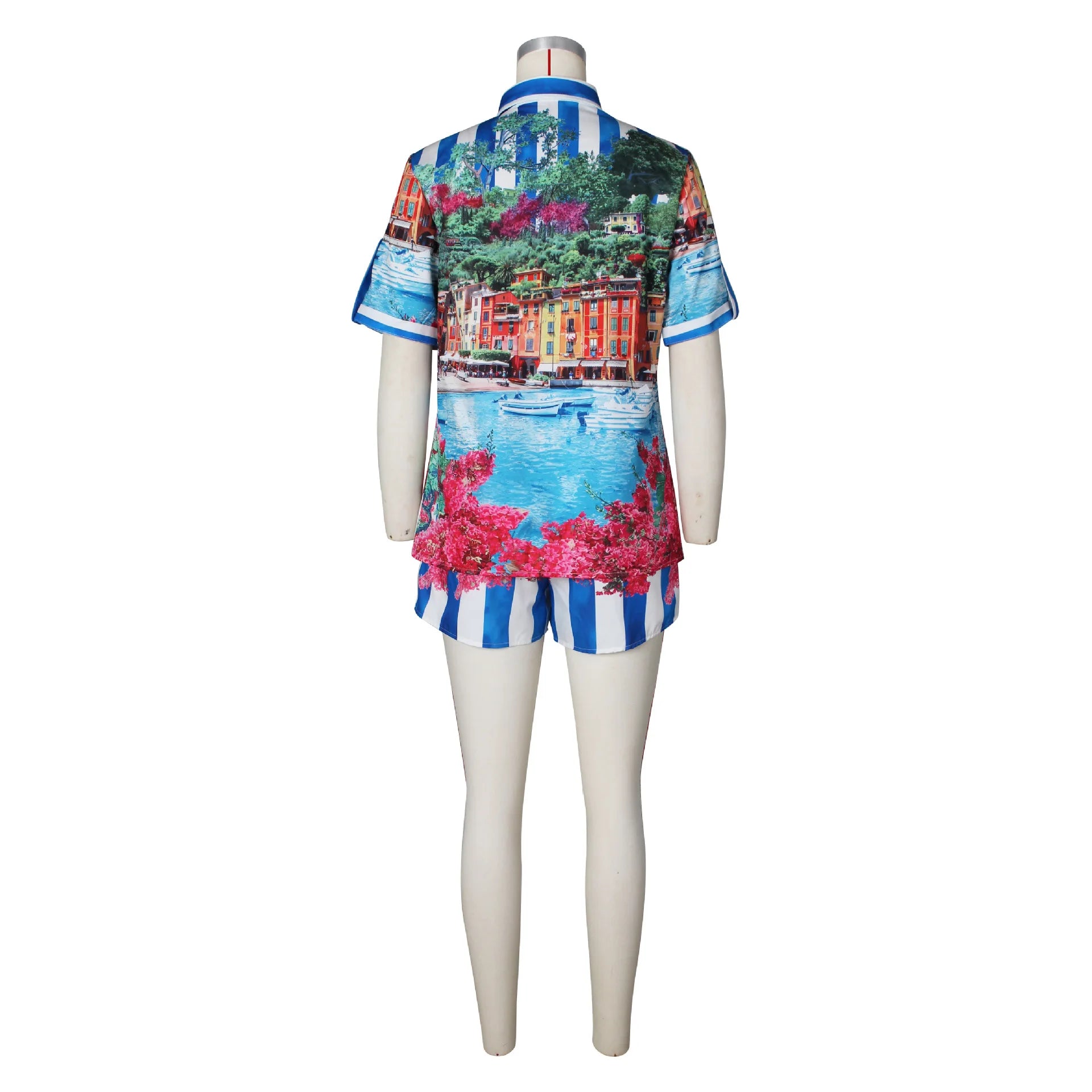 Female mannequin wearing a two-piece summer set with a colorful scenic print t-shirt and striped shorts viewed from back