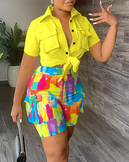 Woman wearing a bright yellow tie-front short sleeve top and colorful abstract print cargo shorts two-piece summer outfit